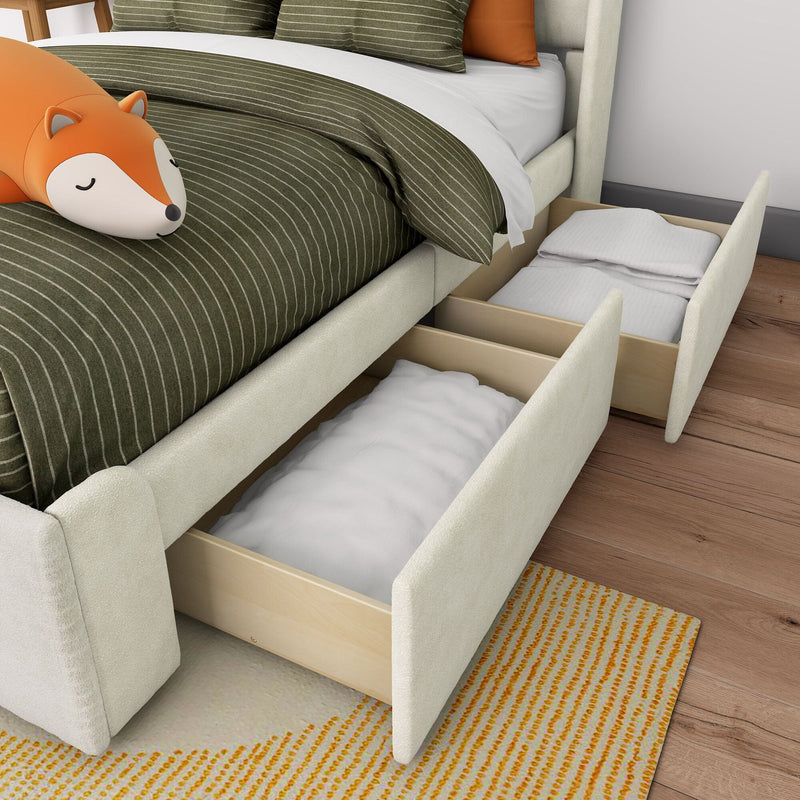 Under-bed storage drawers in upholstered bed frame with olive green pinstripe duvet, orange fox plush pillow and neatly folded linens