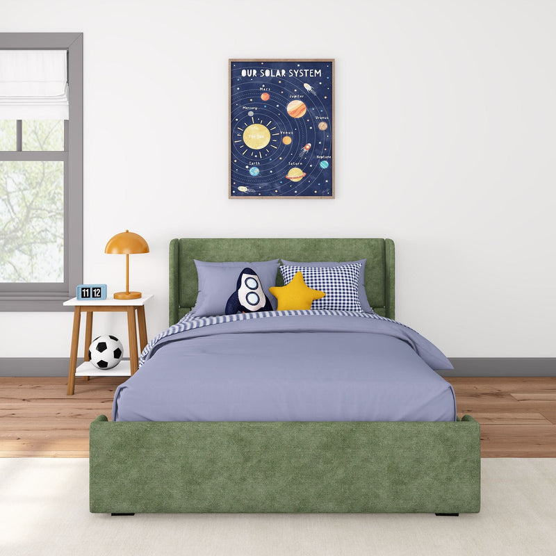 Kids space-themed bedroom with green upholstered bed, blue bedding, rocket and star pillows, framed solar system poster above bed, orange bedside lamp, wooden nightstand, digital clock and soccer ball.