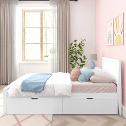 Modern bedroom with white platform bed, blue and pink accents, and large window.