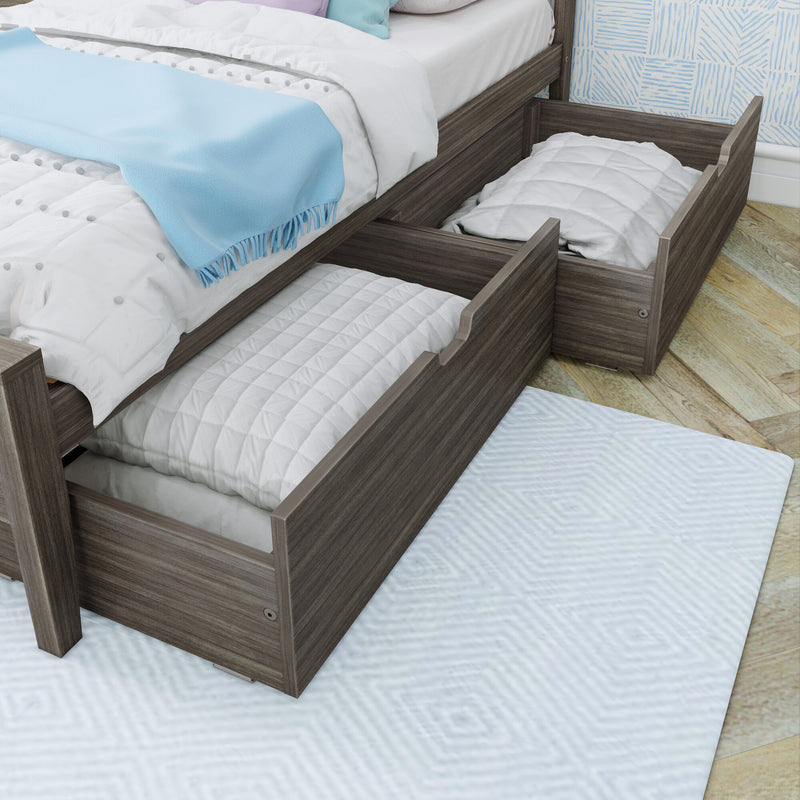 Gray wood trundle bed with under-bed pull-out storage drawers, white quilted bedding and light blue throw blanket