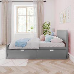 Gray bed with storage drawers in a bright bedroom featuring pink walls, large window, and decorative plants.