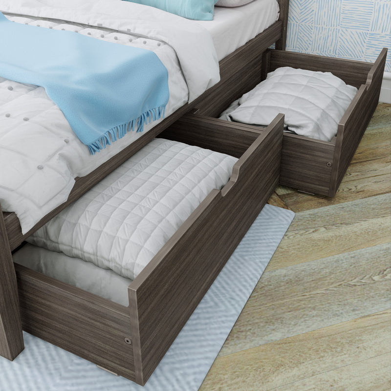 Wooden bed frame with pull-out trundle storage drawers, white quilted bedding and light blue throw blanket on hardwood floor — space-saving underbed storage solution for small bedrooms
