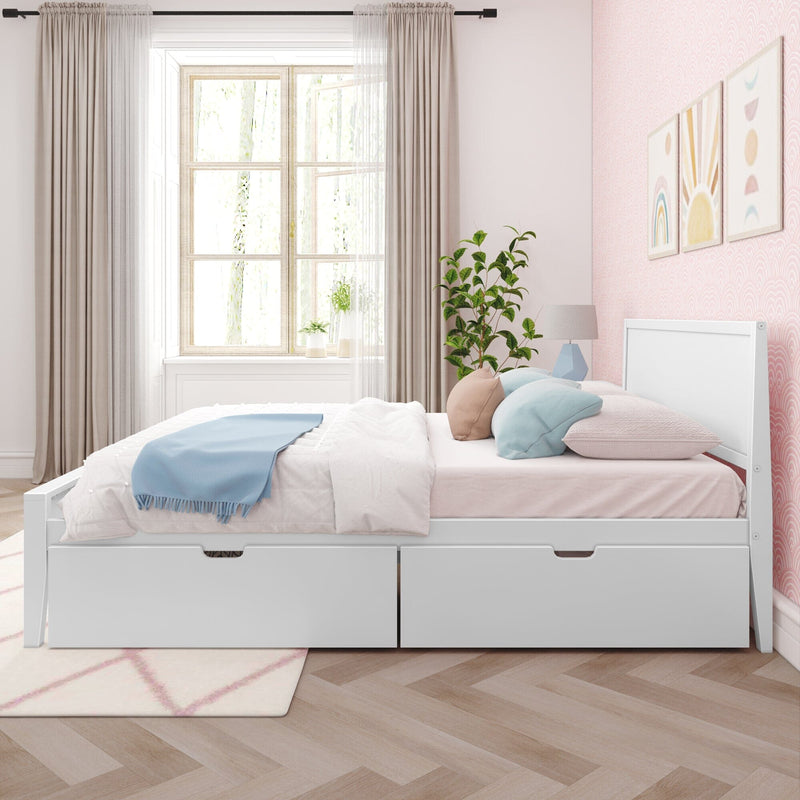 White platform storage bed with two under-bed drawers in a pastel pink girl’s bedroom, large window with curtains, blue throw and decorative pillows, indoor plant and wall art