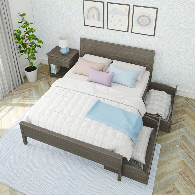 Modern bedroom with dark wood platform bed and under-bed storage drawer, white quilt and pastel pillows, wood nightstand with blue lamp, potted plant, three framed nursery prints and light blue patterned wallpaper on herringbone hardwood floor