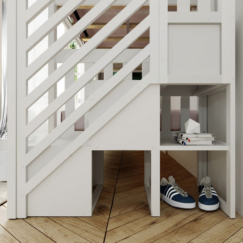 White wooden loft bunk bed with diagonal slat staircase and built-in storage cubbies, stack of books and navy sneakers on hardwood floor in a modern kids' bedroom