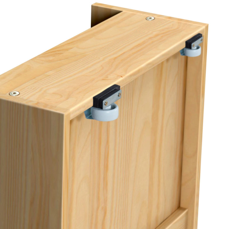 Close-up of light pine wooden furniture panel with two grey roller caster wheels mounted on metal brackets — cabinet hardware for sliding drawers and doors