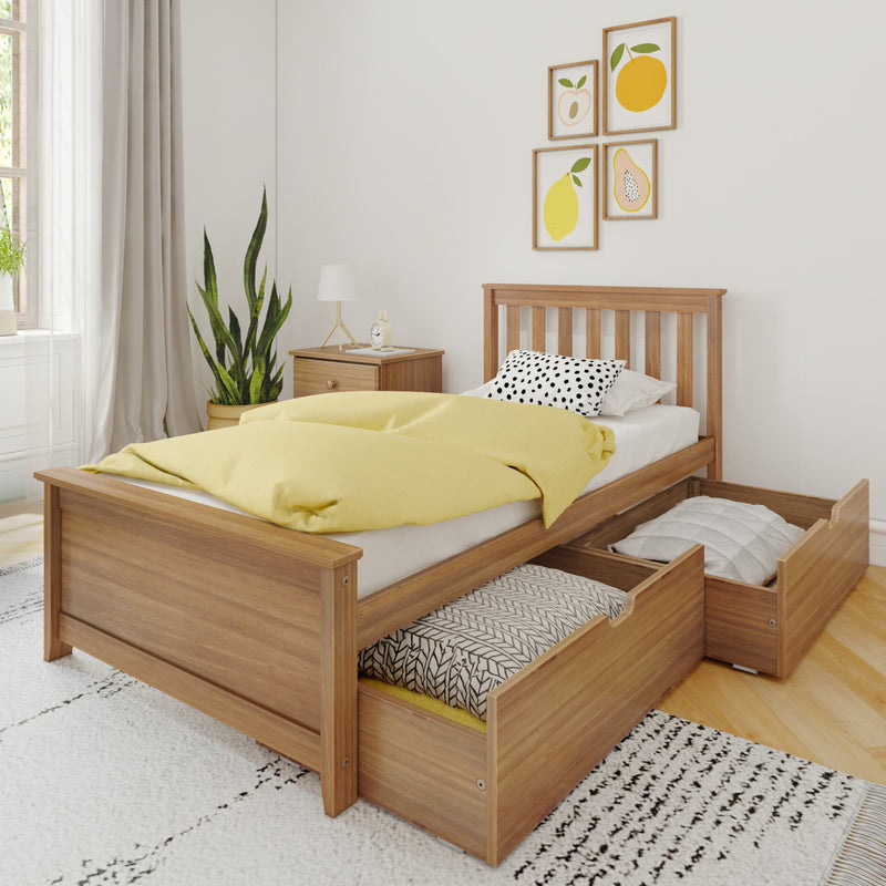 Minimalist Scandinavian bedroom with a wooden platform bed featuring pull-out under-bed storage drawers, yellow duvet, polka-dot pillow, bedside table, plant, and framed fruit wall art