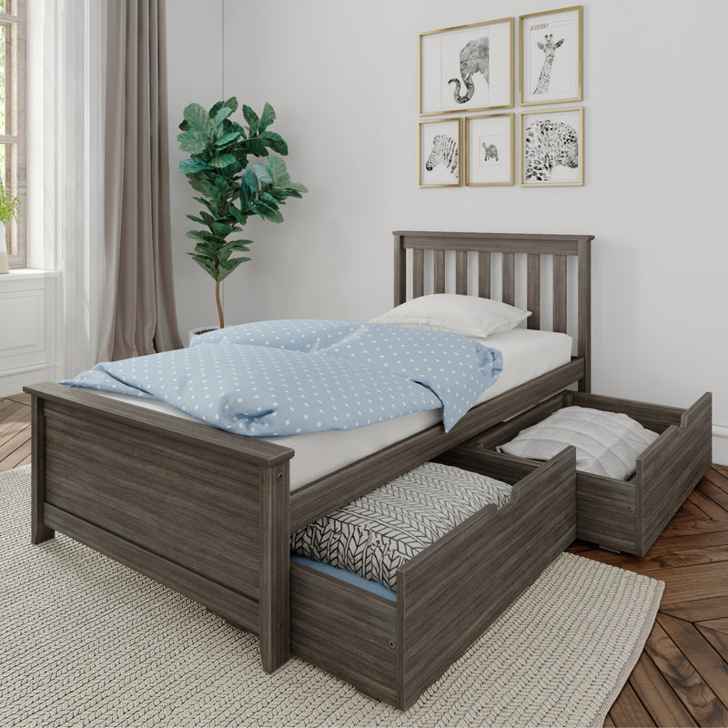 Gray wood toddler bed with pull-out underbed storage drawers, blue polka-dot bedding, fiddle leaf fig plant and framed animal prints in a bright modern kids bedroom/nursery