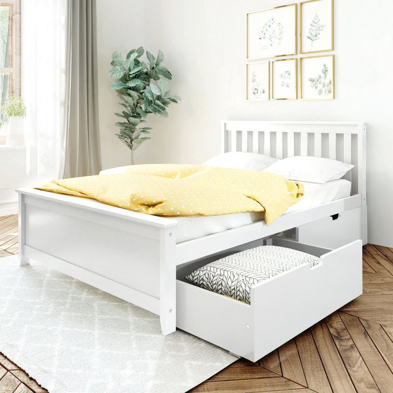 White wooden platform storage bed with slatted headboard and pull-out drawer, dressed in yellow polka-dot duvet and white pillows in a bright modern farmhouse bedroom