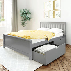 Gray wooden bed frame with storage drawers, yellow polka dot duvet, and white pillows in a bright bedroom with decorative plant and wall art.