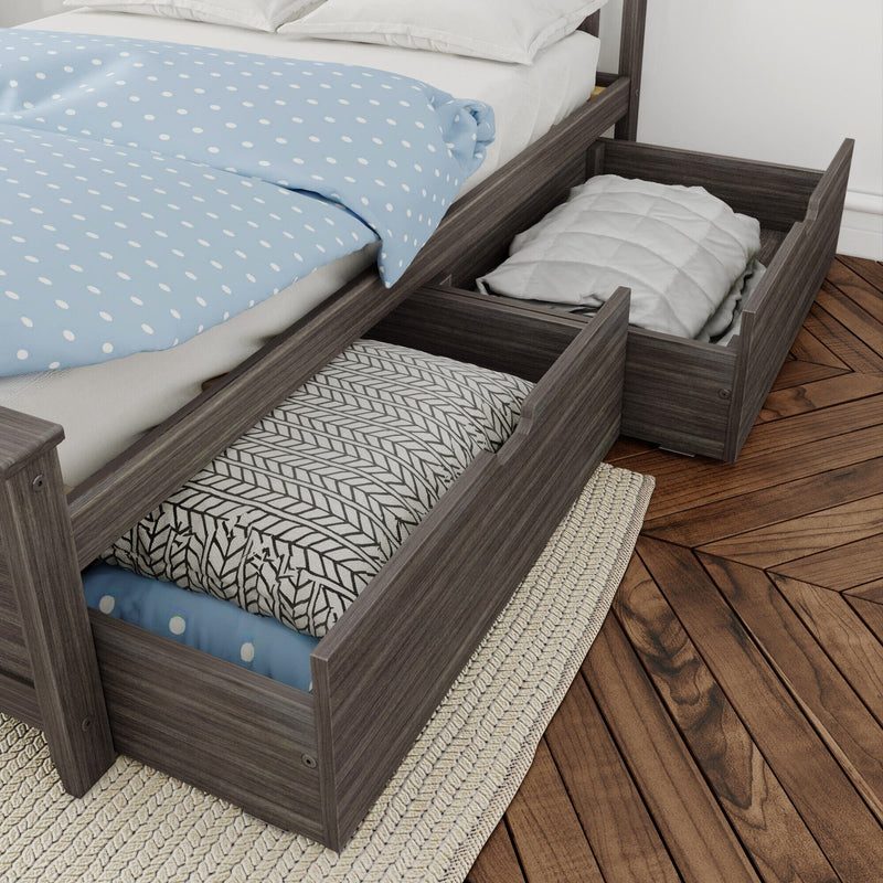 Under-bed storage drawers in gray wood bed frame holding folded linens and pillows beside a blue polka-dot duvet — space-saving bedroom storage solution