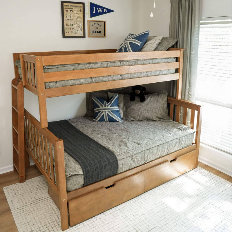 Wooden bunk bed with pull-out trundle storage, gray bedding and blue nautical accent pillows in a bright kids' bedroom with framed camping wall art
