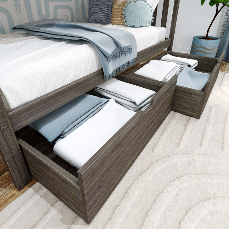 Gray wood platform bed with under-bed storage drawers open, neatly stacked white and blue linens, light-blue throw and decorative pillows in a modern bedroom
