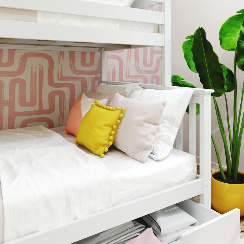 White wooden bunk bed with pink abstract wallpaper, yellow accent pillow, under-bed storage drawer and potted green plant in modern kids bedroom