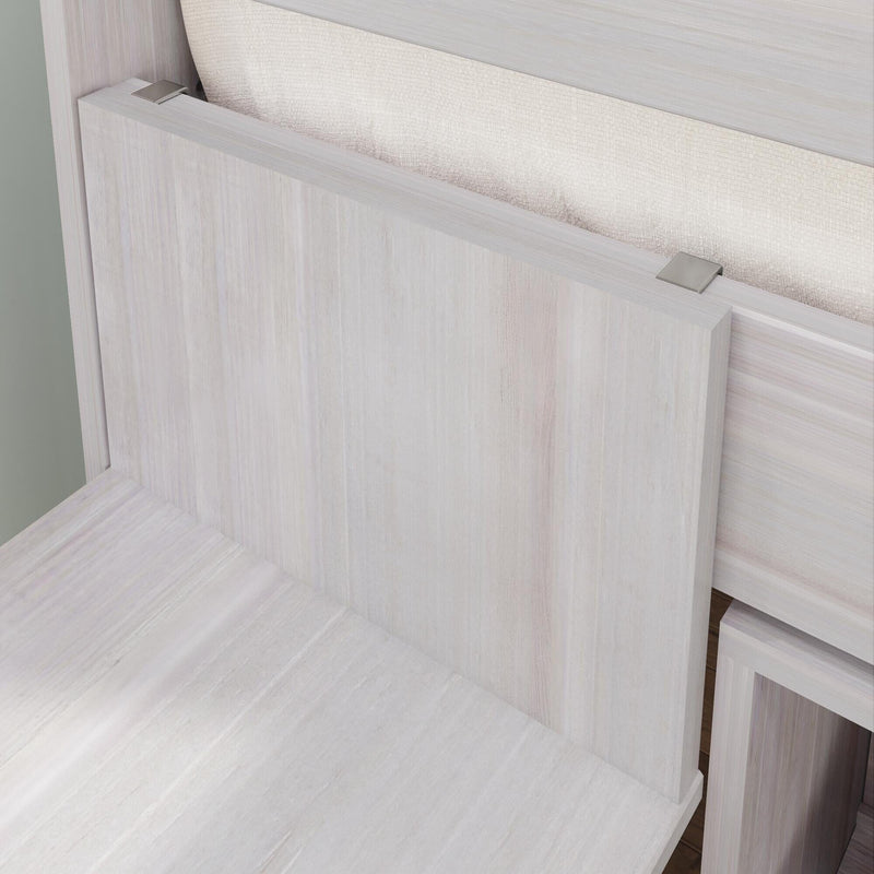 Close-up of whitewashed wood sliding cabinet door with brushed nickel top clips, textured fabric backing and modern minimalist hardware