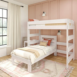 Stylish white bunk bed with beige bedding in a modern bedroom with peach accent wall and natural light.
