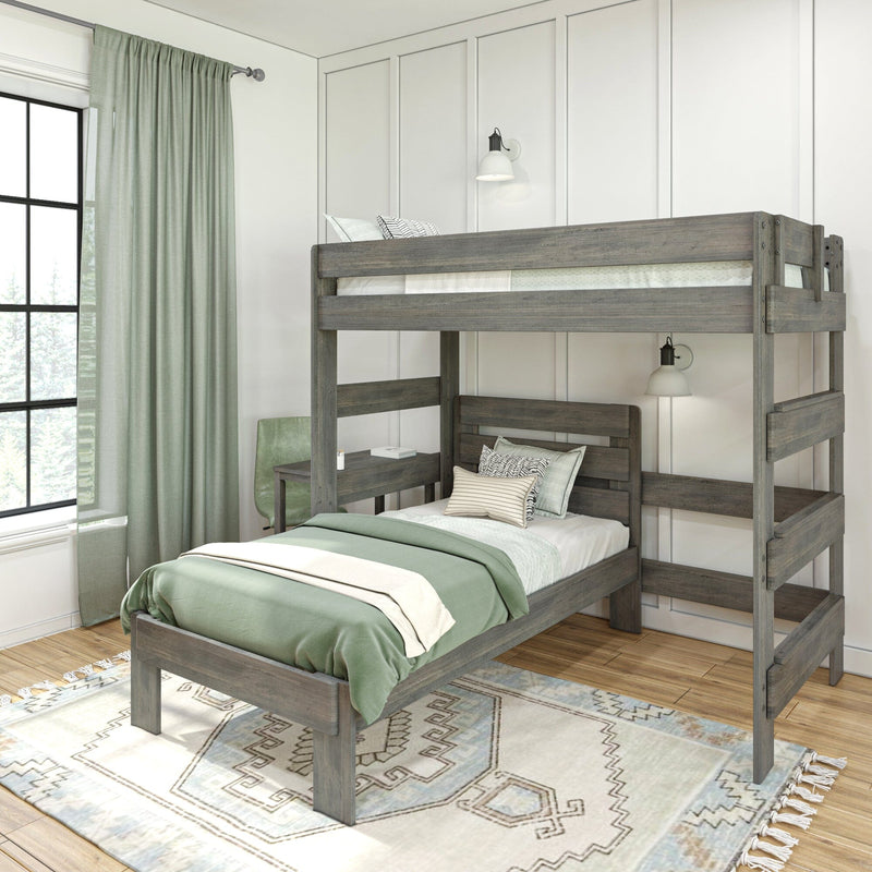 Rustic gray wooden twin-over-twin bunk bed with sage green bedding and curtains in a modern farmhouse kids' bedroom with white paneled wall, study desk, wall sconces and patterned area rug
