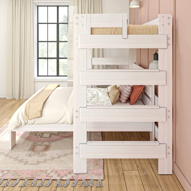 Whitewashed twin-over-twin wooden bunk bed with guardrails next to a platform bed in a modern pastel bedroom with large window, decorative pillows, area rug and hardwood floor