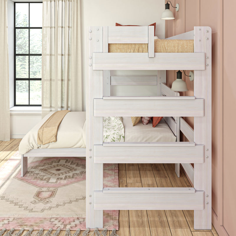 Whitewashed wood bunk bed in a cozy neutral bedroom with sheer curtains, large window, layered bedding and bedside lamp