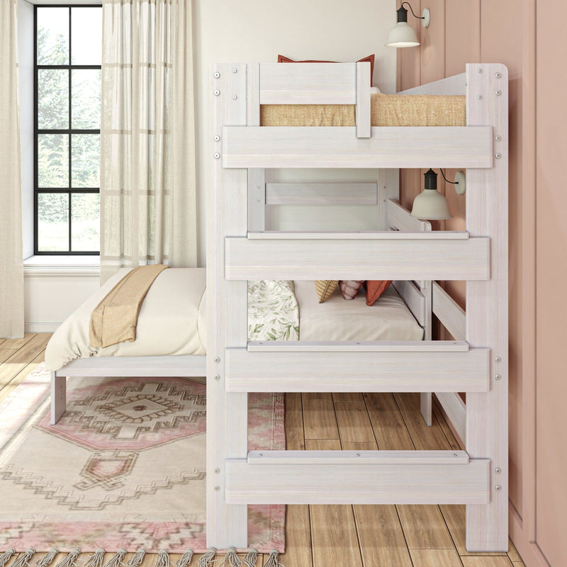 Whitewashed wood bunk bed in a cozy neutral bedroom with sheer curtains, large window, layered bedding and bedside lamp