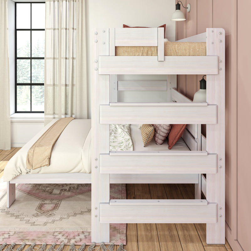Whitewashed wooden bunk bed in bright modern kids' bedroom with neutral bedding, pink accent wall and large window