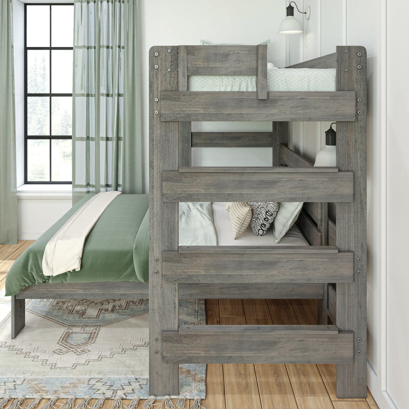 Rustic gray wooden twin-over-twin bunk bed in bright modern farmhouse bedroom with green bedding, patterned pillows, area rug and window with green curtains