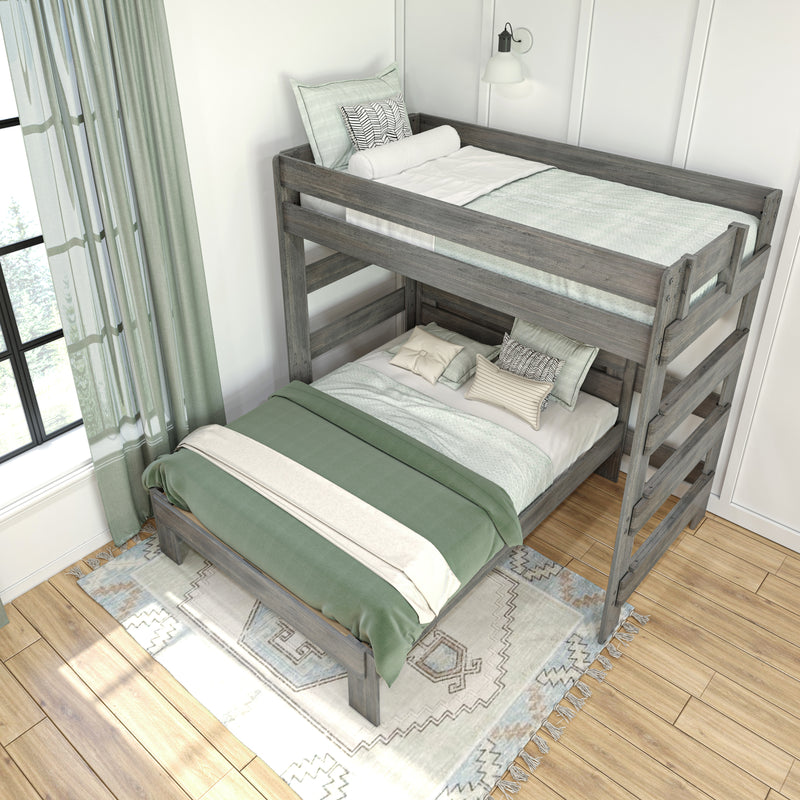 Gray wooden bunk bed with green and white bedding, decorative pillows, patterned rug and sheer curtains in a bright kids bedroom