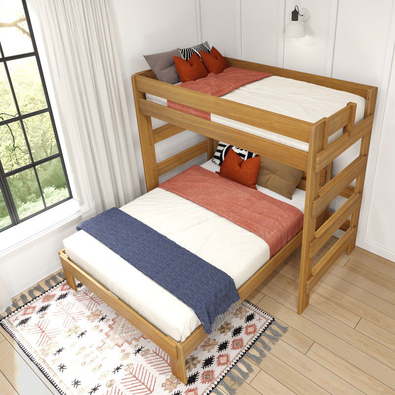 Twin-over-twin wooden bunk bed in natural oak with rust-orange throw pillows, blue bed runner and patterned rug in a bright modern farmhouse bedroom.