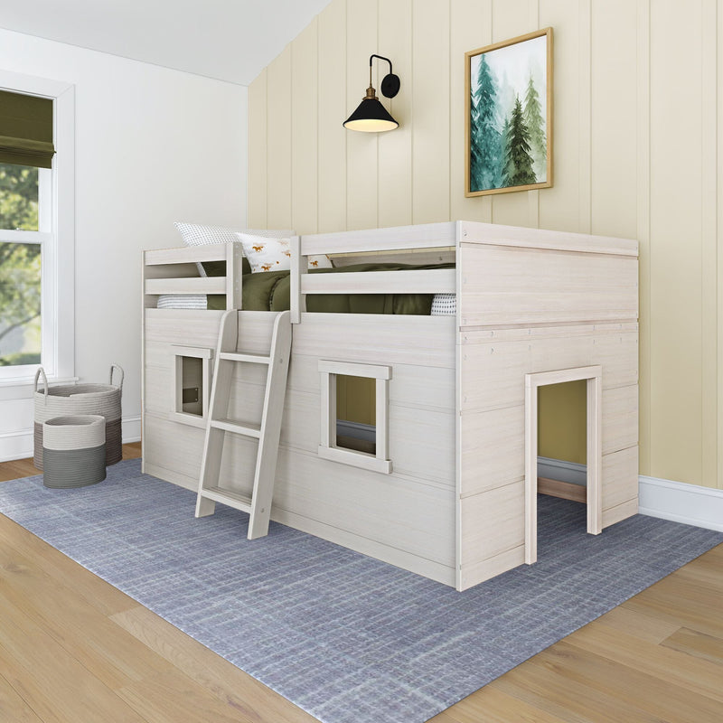 Kids bunk bed playhouse in whitewashed wood with ladder, green bedding, wall sconce and framed pine-tree art in a modern children's bedroom