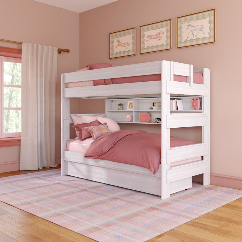 White wooden twin-over-full bunk bed with pink bedding, built-in shelves and under-bed storage drawers in a pastel pink children's bedroom with framed horse prints and a plaid area rug