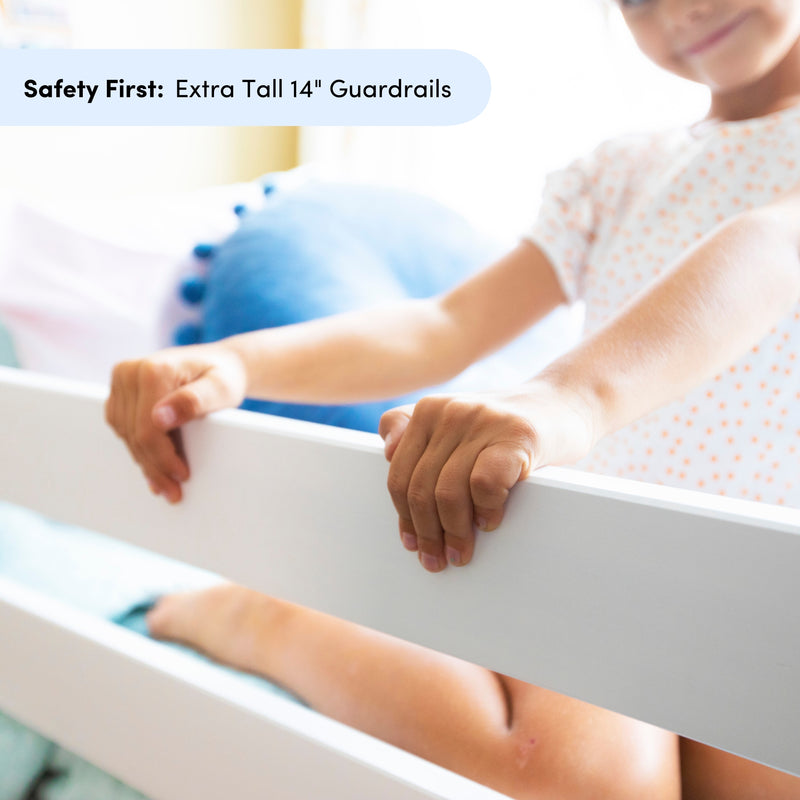 Child holding white extra-tall 14-inch guardrail on bunk bed, safety-first kids bed rail for secure children's bedroom