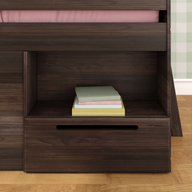 Dark walnut storage bed with built-in open shelf and pull-out drawer holding a stack of pastel books on a hardwood floor.