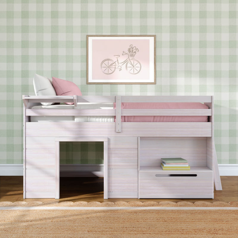 Whitewashed children's loft bed with pink bedding, under-bed playhouse space and storage drawers against green gingham wallpaper and framed bicycle art