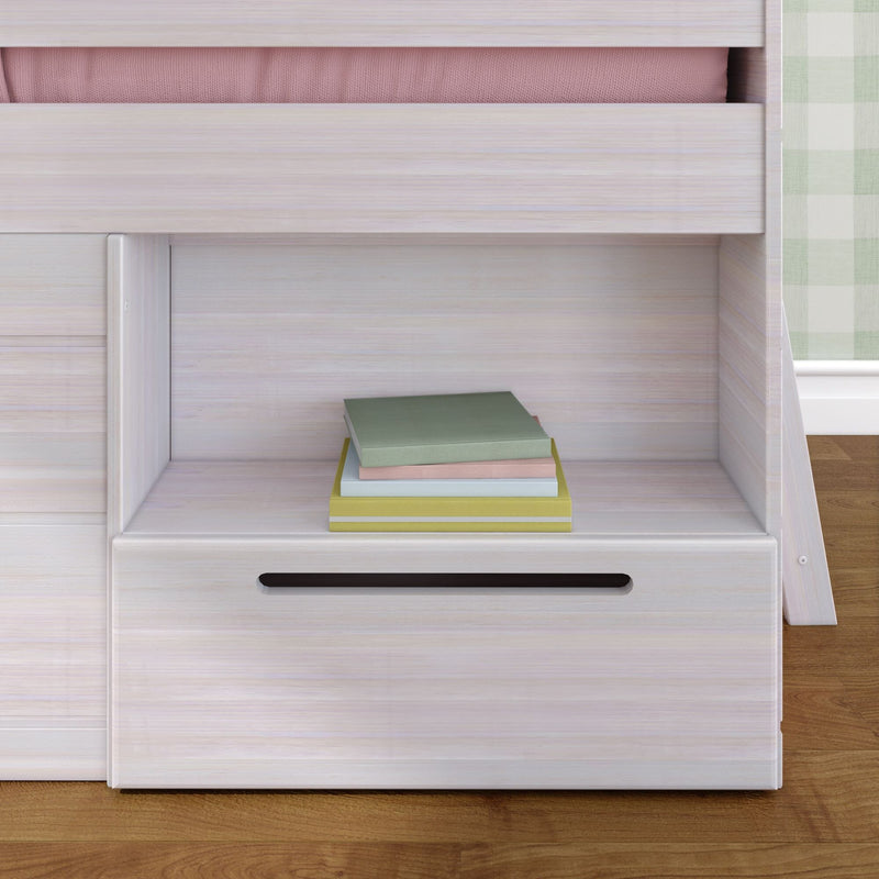 Whitewashed wooden bunk bed shelf in kids bedroom with stacked pastel books, built-in drawer and green plaid curtain