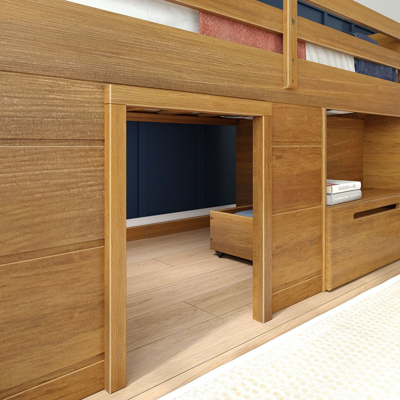 Oak loft bed with built-in storage drawers and under-bed play nook with rolling drawer and navy accent wall in a modern kids’ bedroom