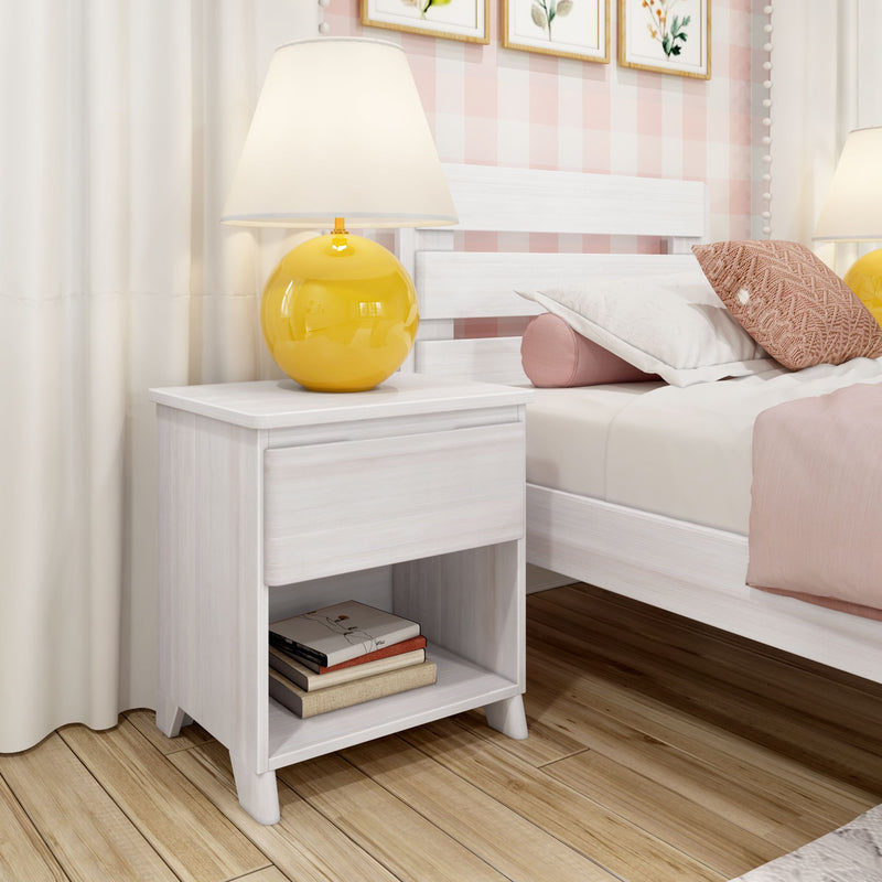 White nightstand with glossy yellow lamp, pink pillows and gingham wallpaper in cozy modern bedroom