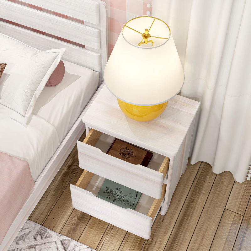 White wooden nightstand with two open drawers and yellow ceramic table lamp beside a white bed with pink bedding on hardwood floor, modern bedroom decor
