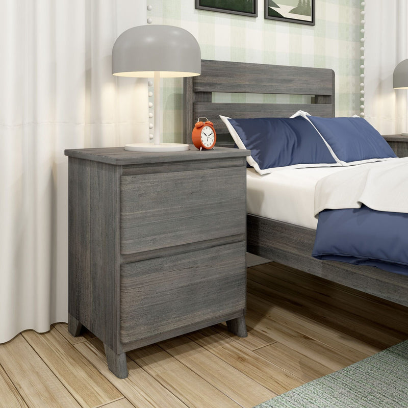 Modern gray two-drawer wooden nightstand with lamp and red alarm clock beside bed with navy blue bedding