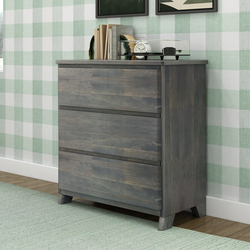 Gray wood bedroom dresser with books, agate bookends, white alarm clock and record player against green-and-white buffalo plaid wallpaper