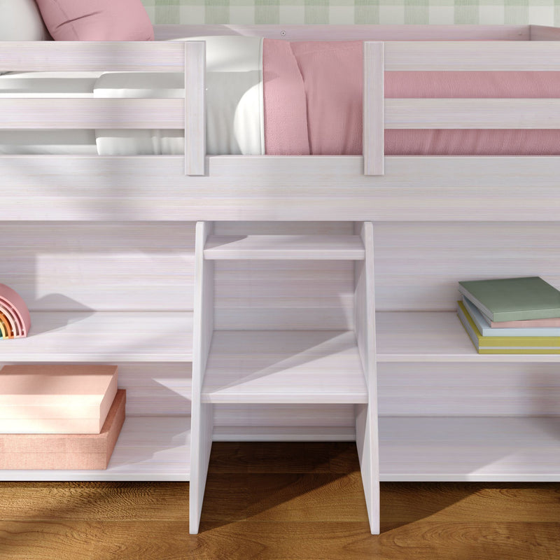 White wooden loft bed with built-in ladder and storage shelves, pink bedding, stacked books and boxes on hardwood floor in children's bedroom