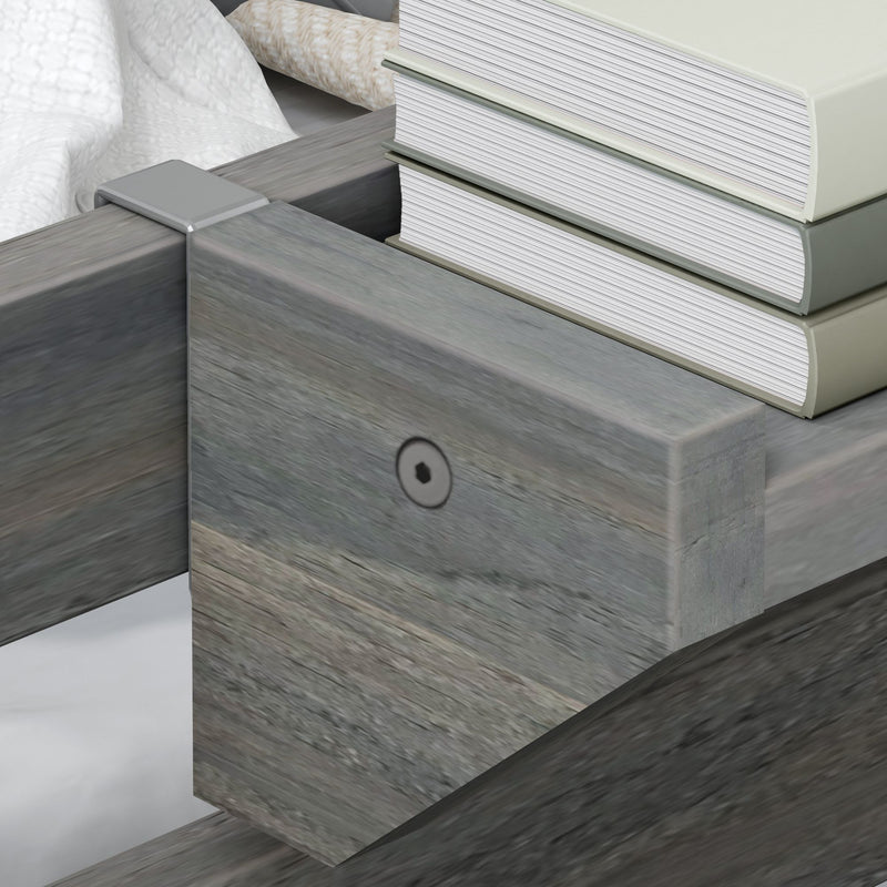 Close-up of a wooden bed frame corner with a metal bracket and stacked hardcover books used as DIY mattress support next to white bedding
