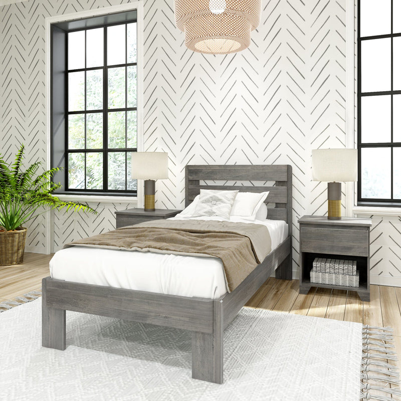 Modern farmhouse bedroom with gray wood bed, matching nightstands and lamps, herringbone wallpaper, black-framed windows, woven pendant light and potted fern