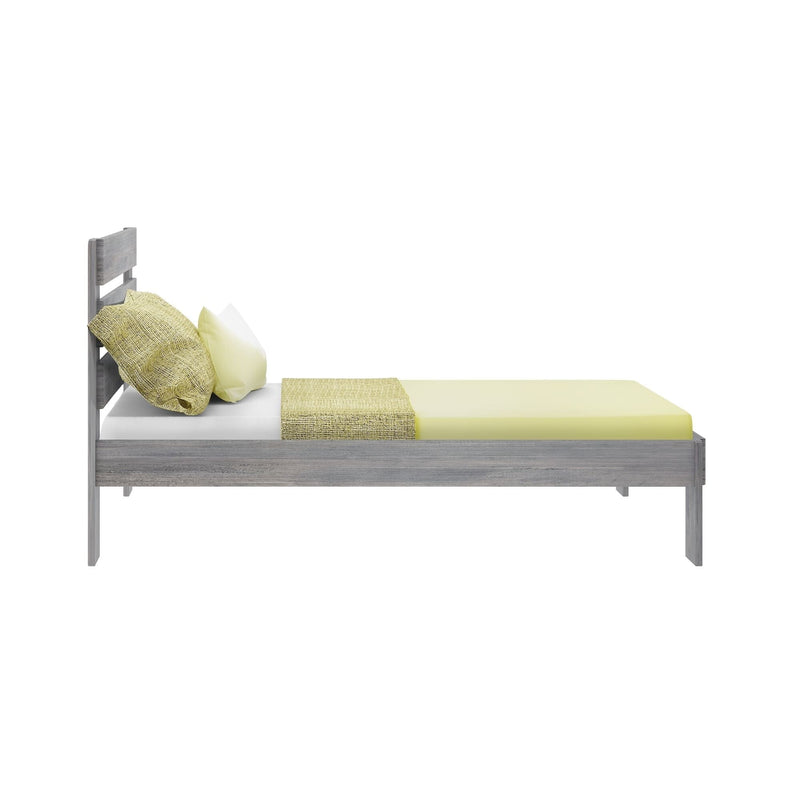 Modern gray wooden platform bed with pale yellow fitted sheet, textured yellow pillows and matching throw on white background