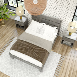 Stylish modern bedroom with wood flooring, gray bedframe, white and beige bedding, and cozy lighting fixtures.