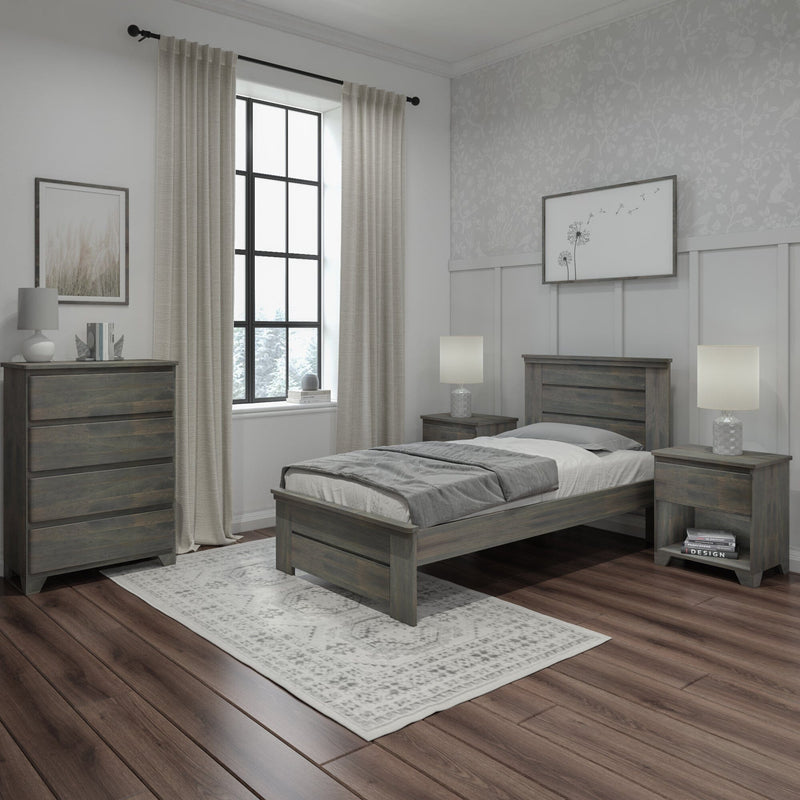 Modern neutral bedroom interior with gray wood platform bed, matching dresser and nightstands, soft gray bedding, hardwood floors, patterned area rug, black-framed window with beige curtains and floral accent wallpaper