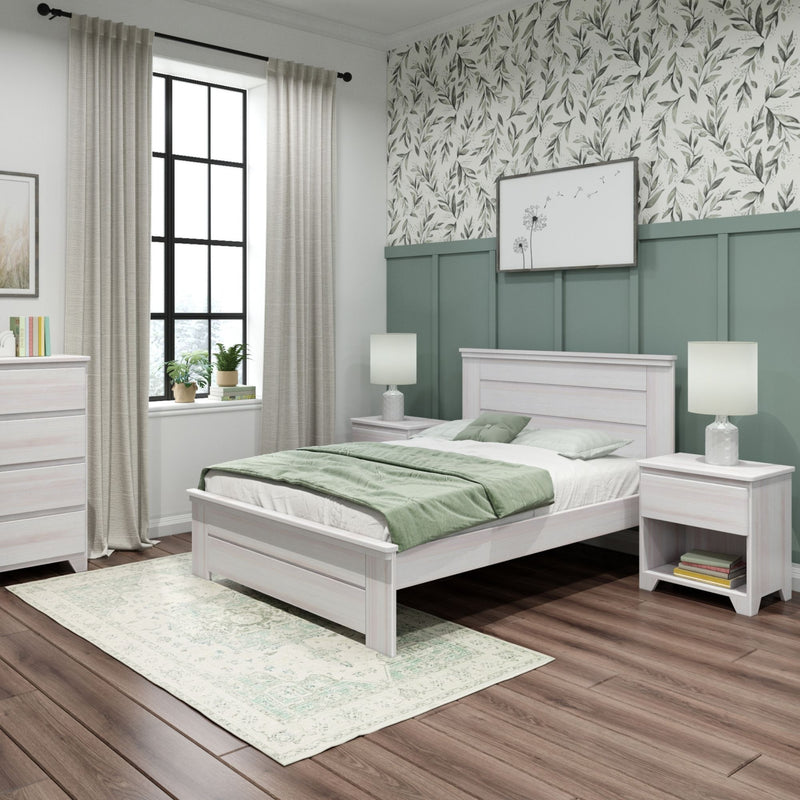 Modern farmhouse bedroom with whitewashed wood bed, sage green wainscoting, botanical leaf wallpaper, soft green bedding, neutral curtains and hardwood floors