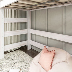 Modern loft bed interior space with a cozy bean bag chair and decorative pillow, featuring a neutral color scheme and soft textures.