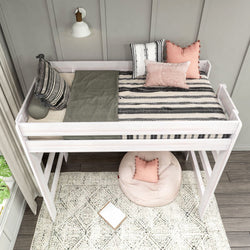 Loft bed with modern decor and striped bedding in a stylish room.