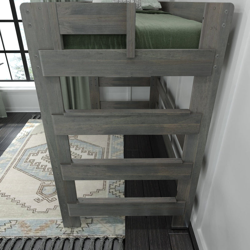 Gray wooden loft bunk bed ladder and guardrail with green bedding, patterned area rug and window