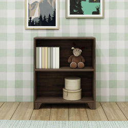 Wooden bookshelf with books, a stuffed moose toy, and decorative boxes against plaid wallpaper background.